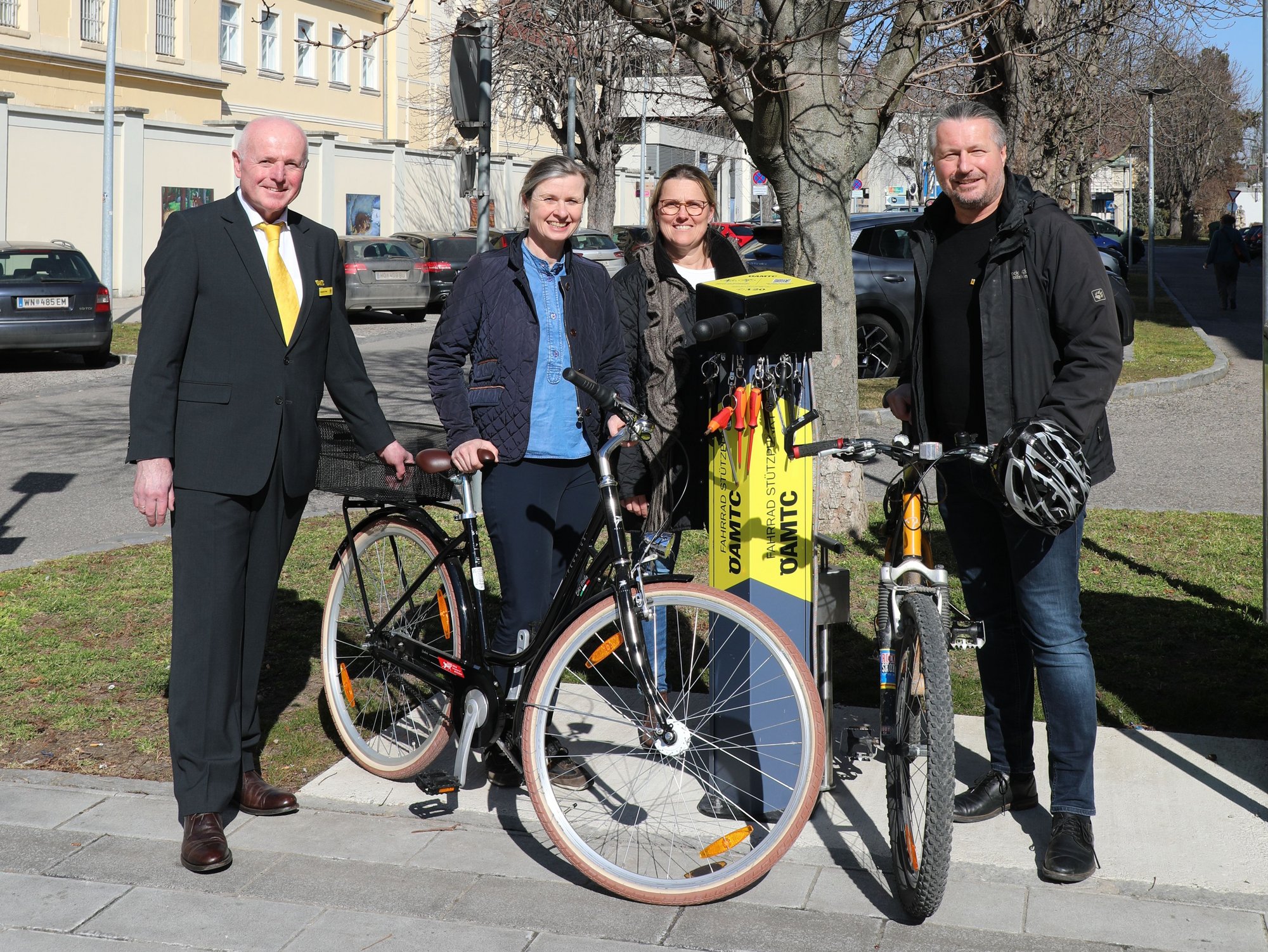 Vier Personen stehen mit Fahrrädern neben einer neuen Fahrrad-Reparaturstation in Krems.