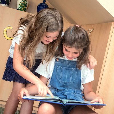 Schülerinnen lesen ein Buch